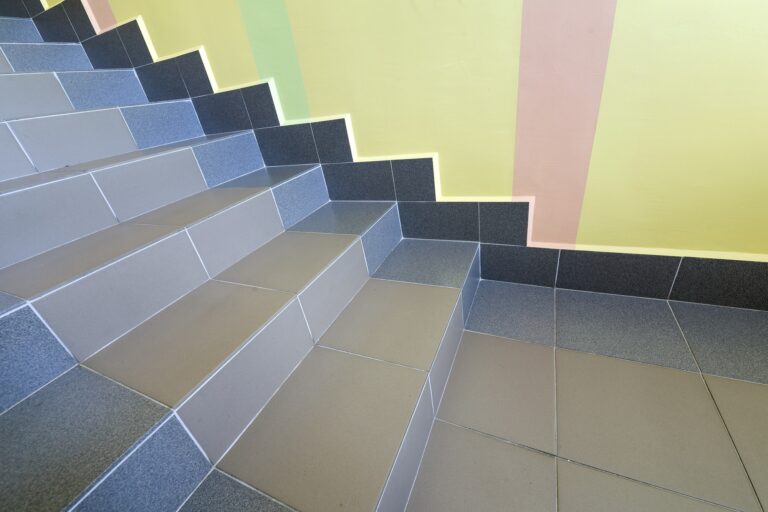 Wide staicase covered with ceramic tiles indoors in a house interior